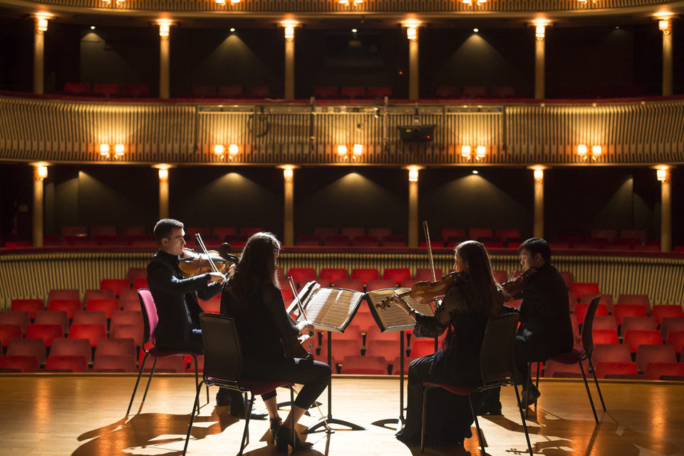 A string quartet playing on stage at the RCM's Britten Theatre